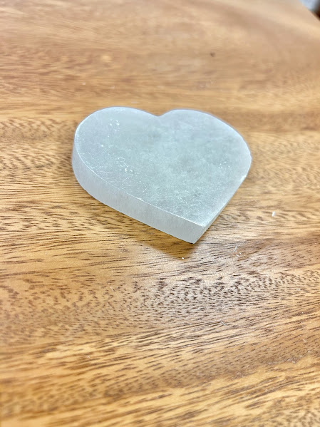Close-up of the large heart-shaped selenite decoration showcasing its texture and sheen.