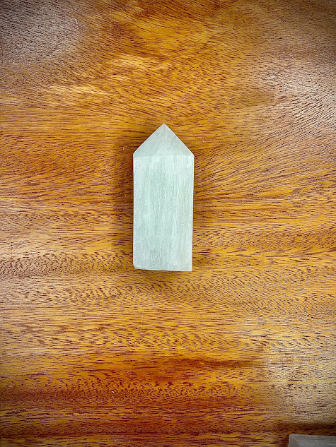 Close-up of the Selenite Obelisk, showcasing its polished surface and pointed tip.