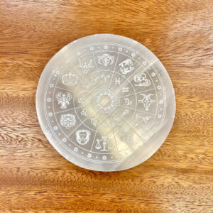 Top view of the Selenite Zodiac Altar on a wooden surface, highlighting the entirety of the zodiac design.