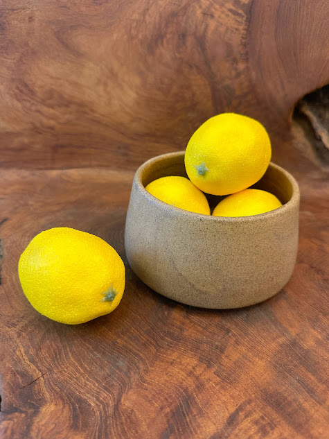 Legian Luxe Bowl with a rustic charm, filled with vibrant lemons on a wooden surface