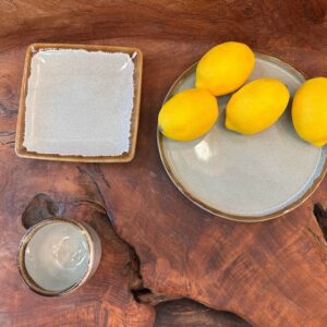 Seminyak Chic Set on a wooden background with lemons, capturing a tropical, modern vibe
